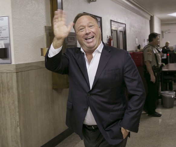 FILE- In this April 19, 2017, file photo, Alex Jones, a well-known Austin-based broadcaster and provocateur, arrives for a child custody trial at the Heman Marion Sweatt Travis County Courthouse in Au ...