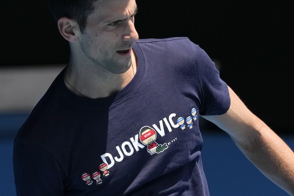 FILE - Defending men&#039;s champion Serbia&#039;s Novak Djokovic practices on Rod Laver Arena ahead of the Australian Open tennis championship in Melbourne, Australia, Wednesday, Jan. 12, 2022. The d ...