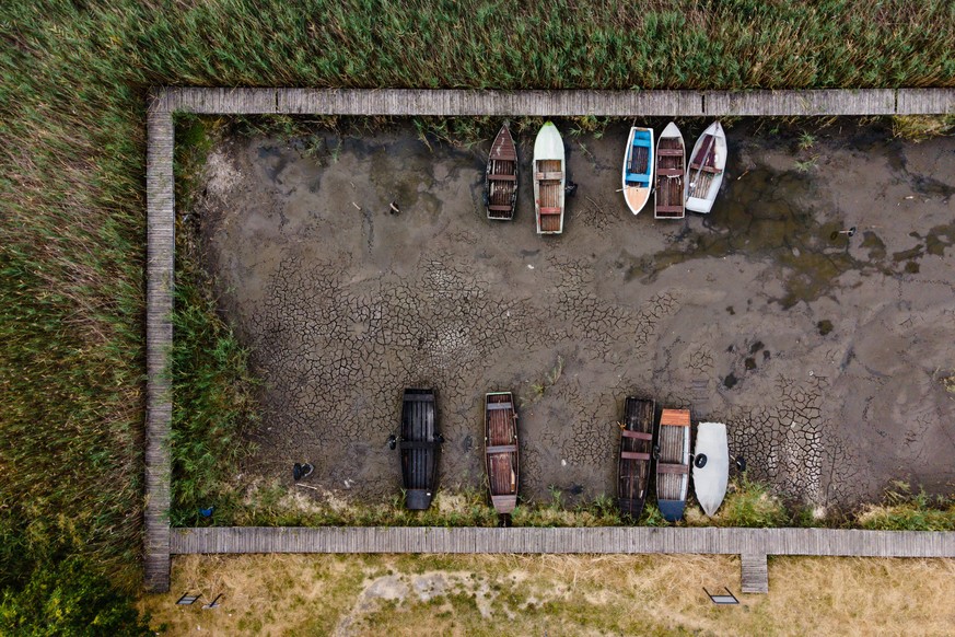 epa10095338 This drone picture shows disused row boats at a dried-out pier of Lake Velence at Pakozd, Hungary, 28 July 2022. A popular holiday destination for domestic visitors, Hungary