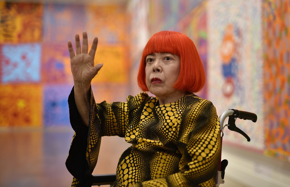 epa13193751 (FILE) - Japanese artist Yayoi Kusama poses with her artwork during a media preview for the 'Yayoi Kusama: My Eternal Soul' exhibition at the National Art Center in Tokyo, Japan, ...