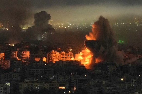 KEYPIX - Smoke and flames rise from buildings following an Israeli airstrike in Dahiyeh, Beirut's southern suburbs, Lebanon, Wednesday, March 11, 2026. (AP Photo/Bilal Hussein)