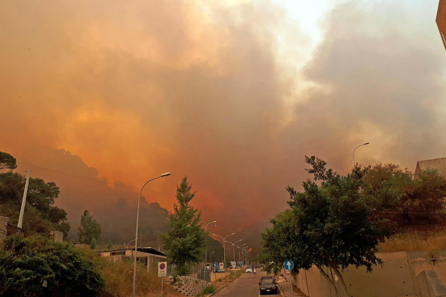 epa06082695 A view of smoke and flames from wildfires affecting an area around the Sicilian city of Messina, southern Italy, 11 July 2017 (issued 12 July 2017). Canadair aircraft from the Air Force, c ...