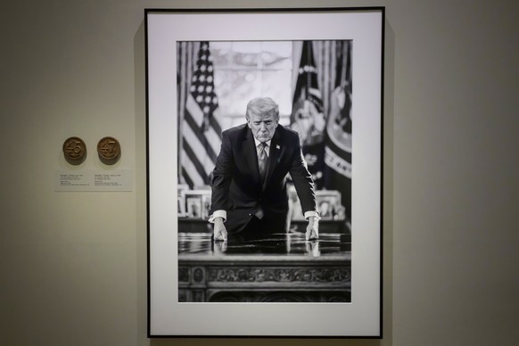 A photograph of President Donald Trump and a short plaque next to it are on display at the Smithsonian's National Portrait Gallery's "American Presidents" exhibit on Sunday, Jan. 1 ...