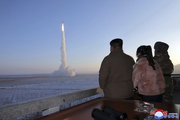 FILE - In this undated photo from Monday, December 12 On August 18, 2023, the North Korean government, North Korean leader Kim Jong Un, his daughter and an official watch what is listed as an intercontinental ball...