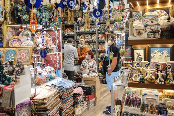 epa09408656 Tourists wearing face masks shop at the historical Grand Bazaar, in Istanbul, Turkey, 10 August 2021. The global COVID-19 pandemic has dealt a major blow to Turkey's tourism industry last  ...