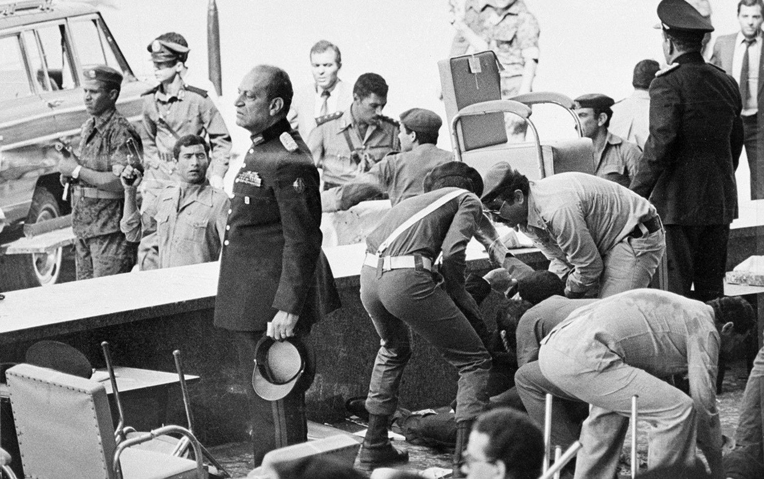 FILE - In this Oct. 6, 1981 file photograph, Egyptian soldiers tend to wounded after an attack on the reviewing platform which killed Egyptian President Anwar Sadat in Cairo, Egypt. Iran&#039;s 1979 I ...