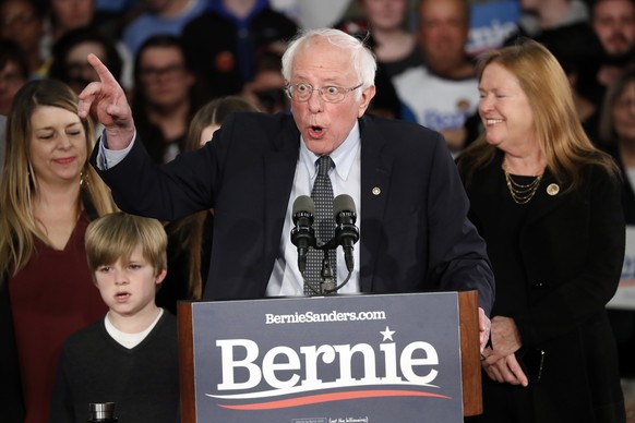 Democratic presidential candidate Sen. Bernie Sanders, I-Vt., with his wife Jane O&#039;Meara Sanders, speaks to supporters at a caucus night campaign rally in Des Moines, Iowa, Monday, Feb. 3, 2020.  ...