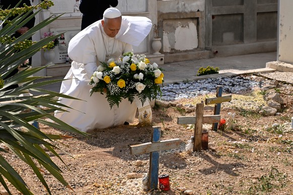Pope Leo XIV pays tribute at the cemetery and on little Joussef's grave, in Lampedusa, Sicily, southern Italy, Saturday, July 4, 2026, during a one-day pastoral visit to an island that has become ...
