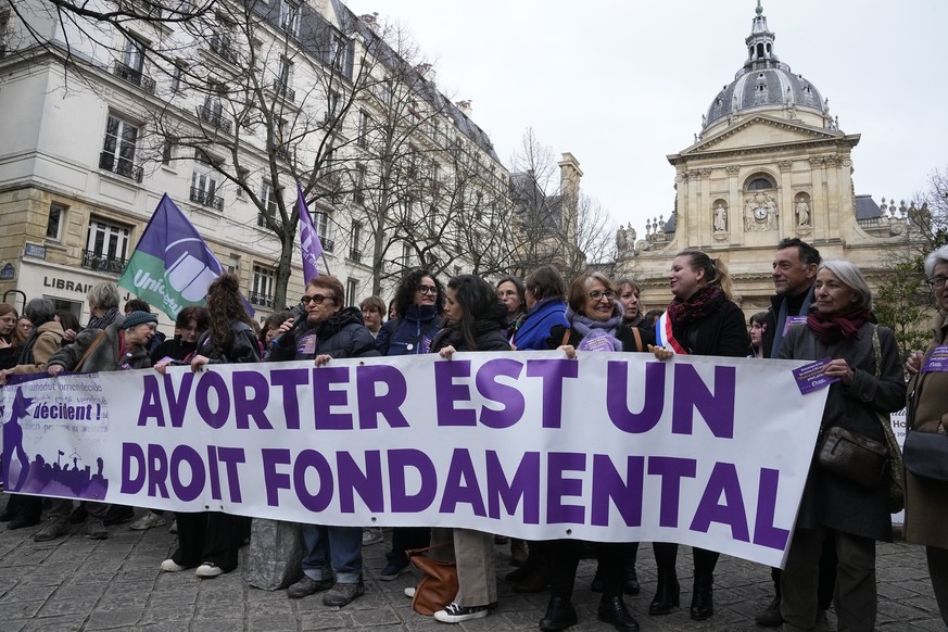 FILE - Pro-abortion rights activists hold banner reads &#039;abortion is a fundamental right&#039; during a rally for abortion rights outside La Sorbonne university in Paris, on Feb. 28, 2024. Abortio ...