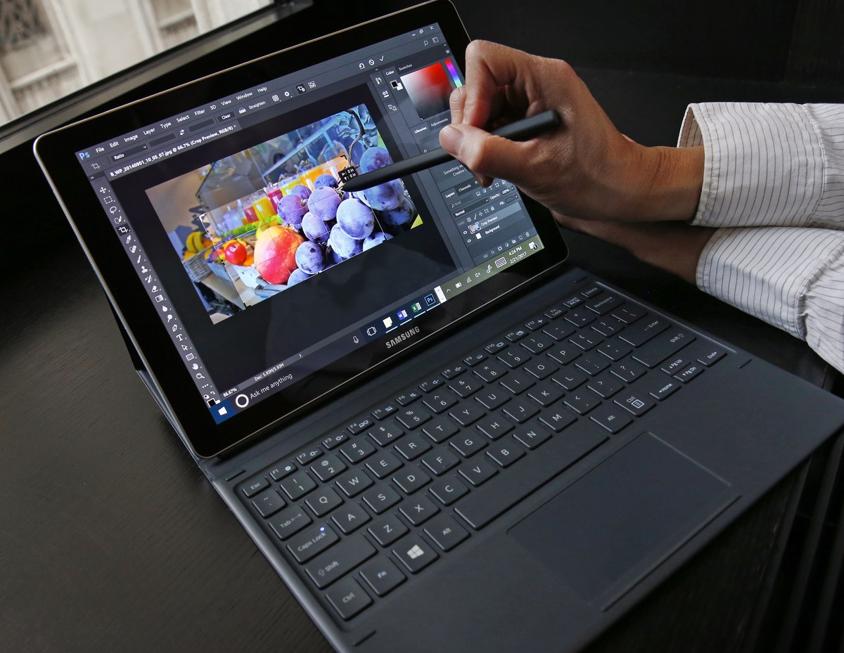 A user demonstrates an S Pen stylus while cropping a photograph on Samsung's 12-inch Galaxy notebook running Windows 10 during a press briefing, Tuesday, Feb. 21, 2017, in New York. The Galaxy Bo ...