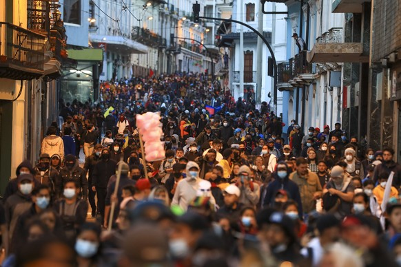 epa10015274 Young people march against the Government of Guillermo Lasso, in Quito, Ecuador, 15 June 2022. The national strike called by the indigenous movement against the economic policy of the Gove ...