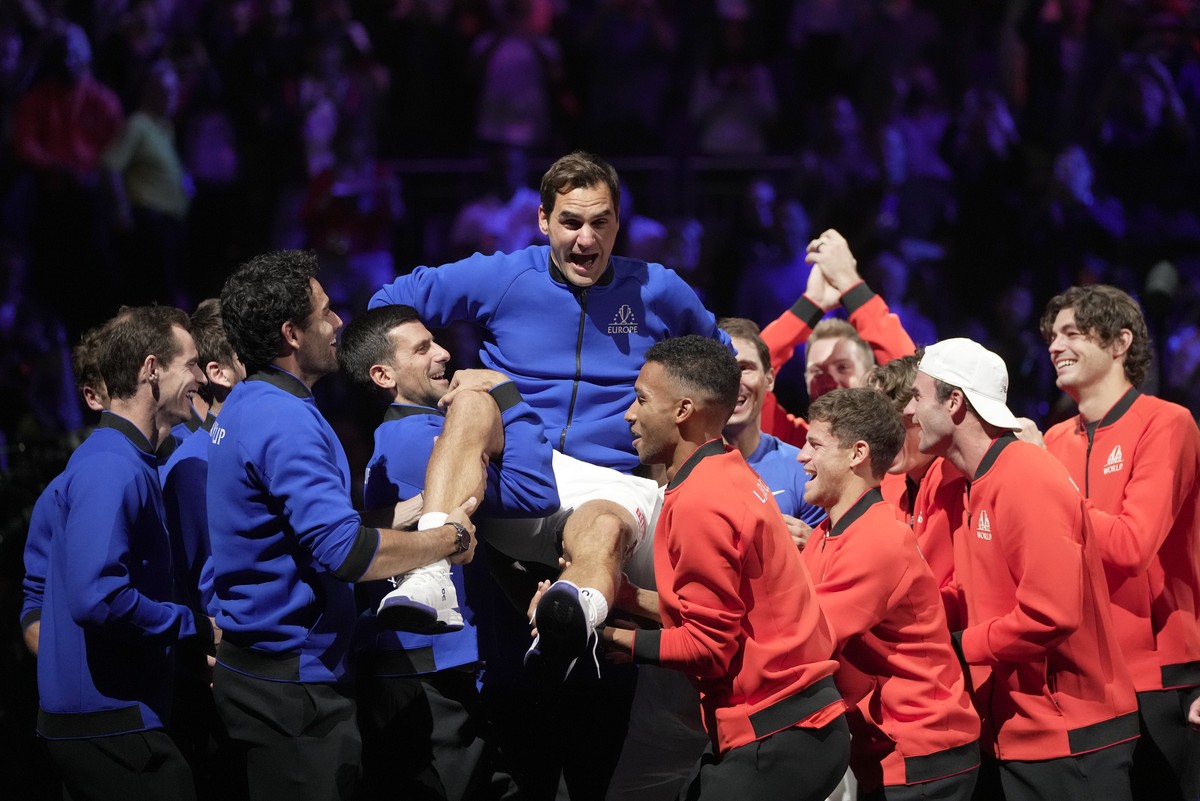 Team Europe's Roger Federer is lifted by fellow players after playing with Rafael Nadal in a Laver Cup doubles match against Team World's Jack Sock and Frances Tiafoe at the O2 arena in Lond ...