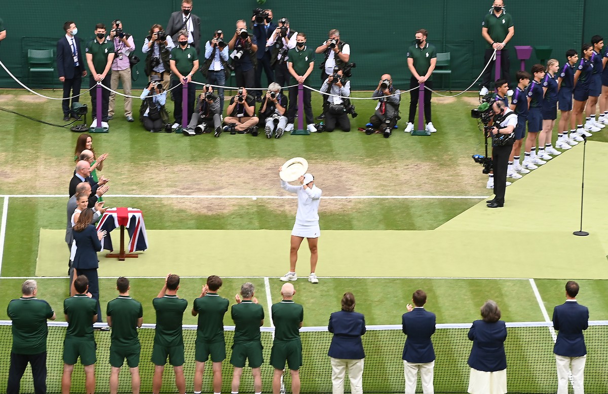 epa09335631 Ashleigh Barty of Australia celebrates with the trophy after winnning her women's final match against Karolina Pliskova of Czech Republic at the Wimbledon Championships, Wimbledon, Br ...