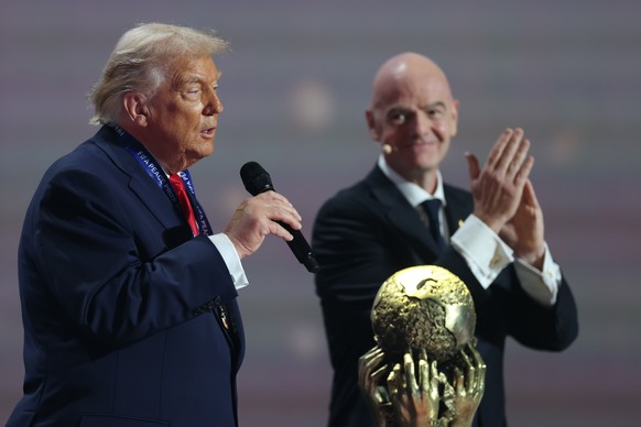 FIFA President Gianni Infantino claps after President Donald Trump received the FIFA Peace Prize during the draw for the 2026 soccer World Cup at the Kennedy Center in Washington, Friday, Dec. 5, 2025 ...
