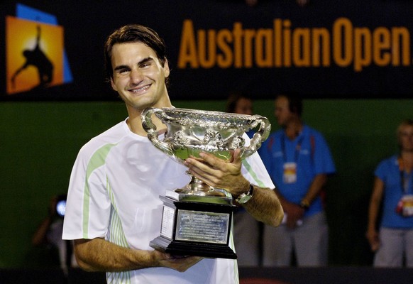 Switzerland&#039;s Roger Federer holds his trophy after winning the men&#039;s singles final against Cypriot Marcos Baghdatis at the Australian Open tennis tournament in Melbourne, Australia, Sunday,  ...