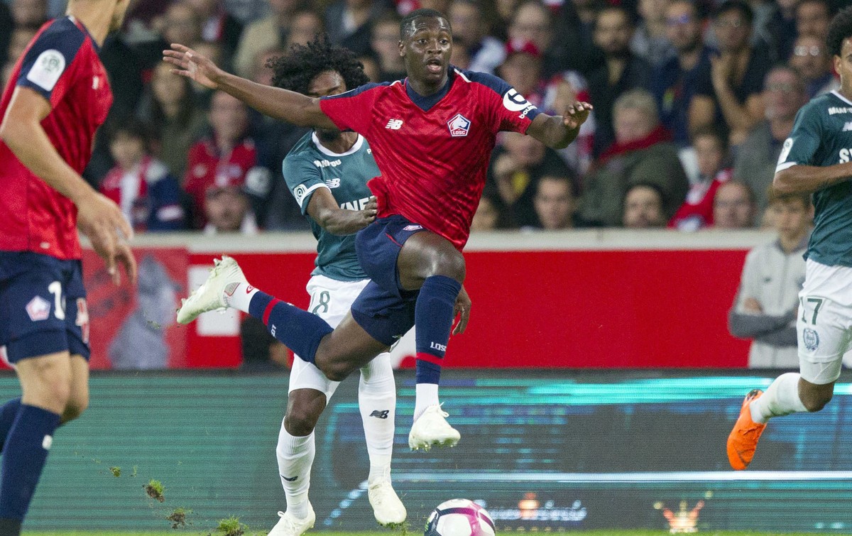 FILE - In this Saturday, Sept. 22, 2018 file photo, Lille's Nicolas Pepe, center, controls the ball during the French League One soccer match against Nantes at the Lille Metropole stadium, in Vil ...