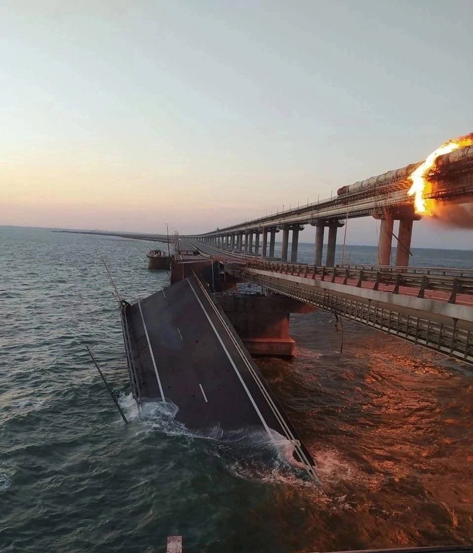 epa10230130 A handout photo made available by the Ukraine Security Service (SSU) shows a collapsed part of the Kerch Strait bridge in Crimea, 08 October 2022. According to Russian authorities, "a ...