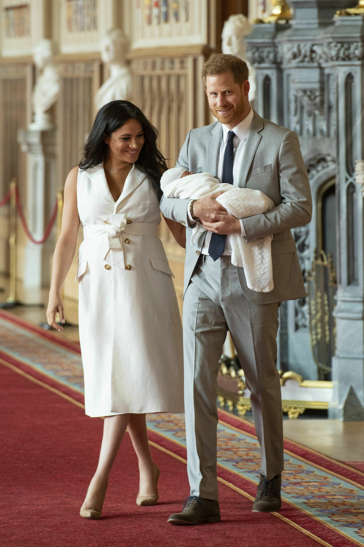 Britain's Prince Harry and Meghan, Duchess of Sussex, arrive for a photocall with their newborn son, in St George's Hall at Windsor Castle, Windsor, south England, Wednesday May 8, 2019. Bab ...