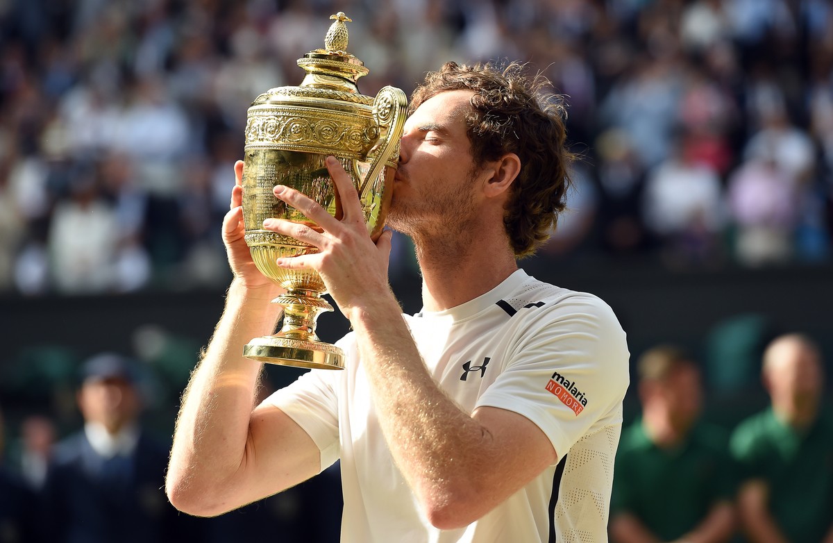 epa07274365 (FILE) - Andy Murray of Britain kisses the championship trophy following his win over Milos Raonic of Canada in the men's singles final of the Wimbledon Championships at the All Engla ...