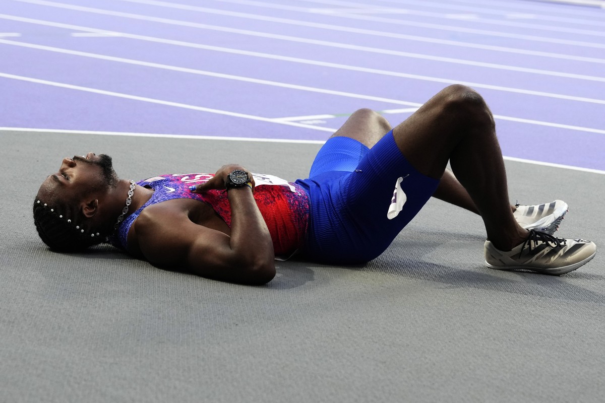 Noah Lyles, of the United States, lies on the track following the men's 200-meters final at the 2024 Summer Olympics, Thursday, Aug. 8, 2024, in Saint-Denis, France. (AP Photo/Petr David Josek)