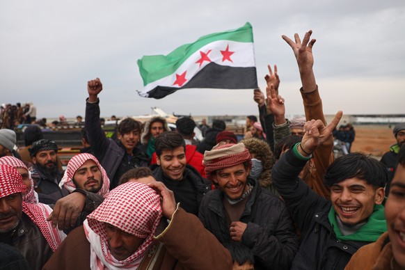 People celebrate as Syrian government forces enter the town of Maskana, Saturday, Jan. 17, 2026, following the withdrawal of the U.S.-backed Syrian Democratic Forces. (AP Photo/Omar Albam)
APTOPIX Syr ...