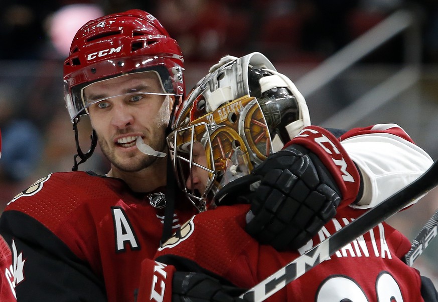 Arizona Coyotes defenseman Niklas Hjalmarsson (4) celebrates with goaltender Antti Raanta after defeating the Ottawa Senators 5-1 in an NHL hockey game, Tuesday, Oct. 30, 2018, in Glendale, Ariz. Ariz ...