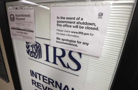 Doors at the Internal Revenue Service (IRS) in the Henry M. Jackson Federal Building are locked and covered with blinds as a sign posted advises that the office will be closed during the partial gover ...