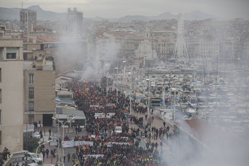 Protesters march during a mass stirke in the Old Port of Marseille, southern France, Wednesday, Dec. 5, 2019. Workers across the public sector fear President Emmanuel Macron&#039;s reform will force t ...