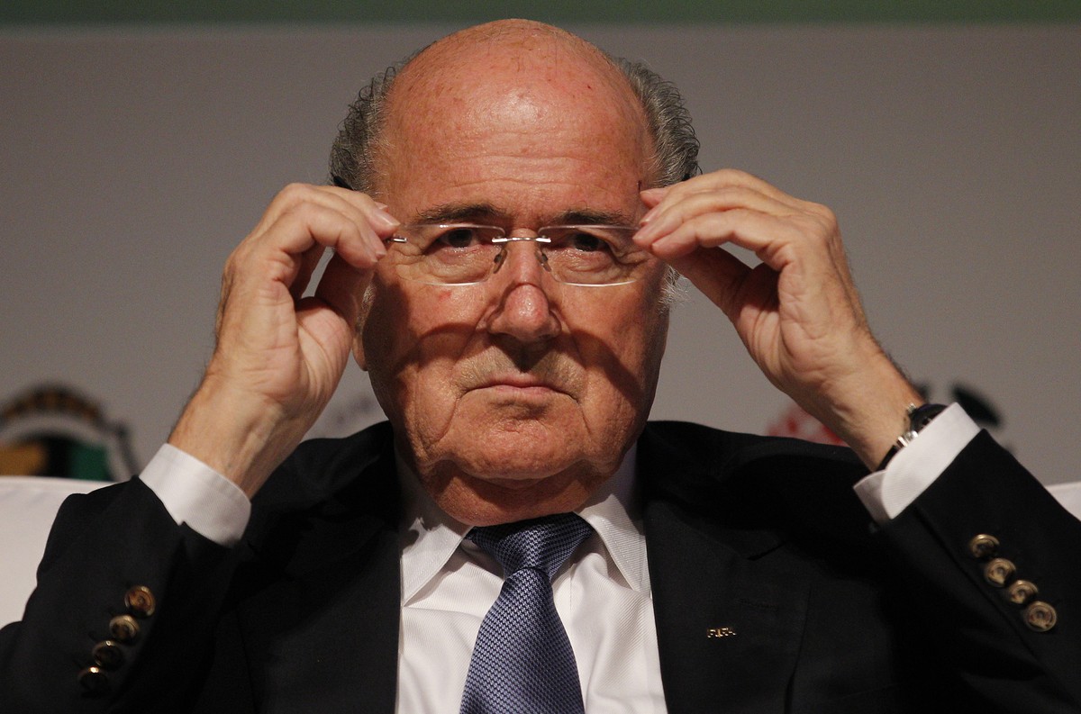 FIFA President Sepp Blatter puts on his glasses as he prepares to speak about the World Cup's impact on Brazilian soccer, during a sports management seminar at the Maison de France theater in dow ...