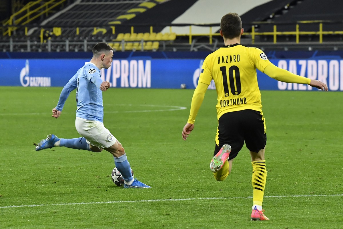 Manchester City's Phil Foden scores his side's second goal during the Champions League quarterfinal second leg soccer match between Borussia Dortmund and Manchester City at the Signal Iduna  ...