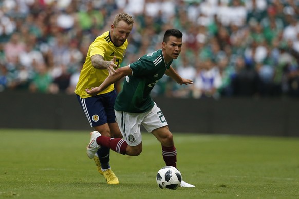 Scotland&#039;s Johnny Russell, left, pressures Mexico&#039;s Hirving Lozano, during a friendly soccer match at Azteca Stadium in Mexico City, Saturday, June 2, 2018. (AP Photo/Rebecca Blackwell)