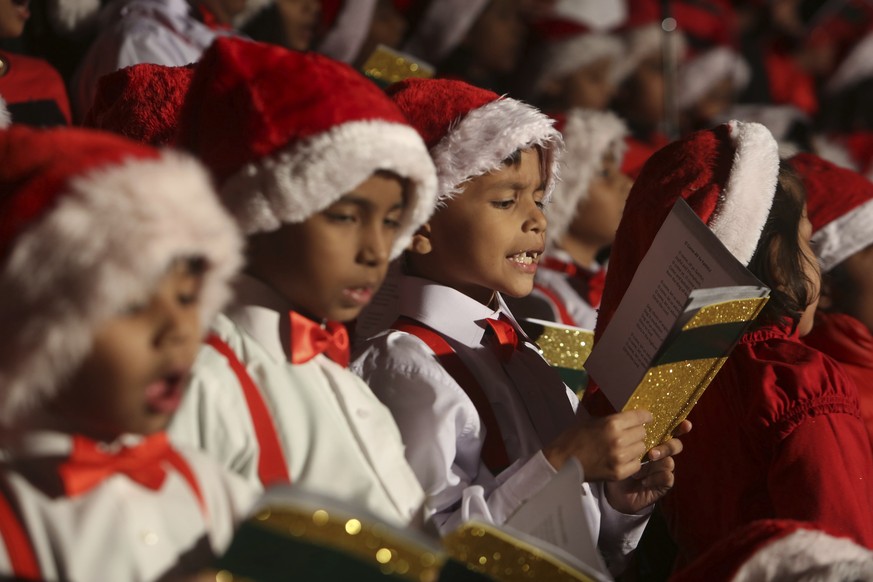 Pakistani Christian children sing a song at Saint Patrick church ahead of the Christmas celebrations in Karachi, Pakistan, Saturday, Dec. 22, 2018. (AP Photo/Fareed Khan)