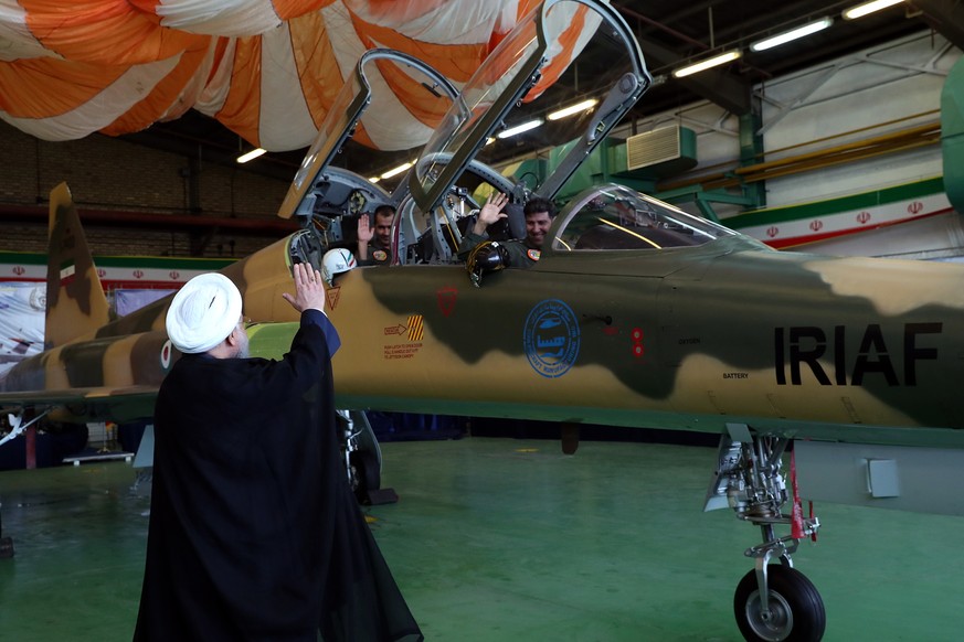 epa06961884 A handout photo made available by the Presidential Office of Iran shows Iranian president Hassan Rouhani waving to pilots during the unveiling of Iran&#039;s first home made fighter jets,  ...