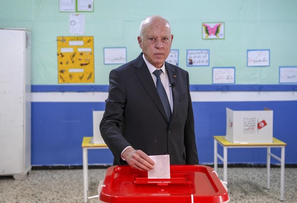 Tunisia&#039;s President Kais Saied casts his ballot as he participates in the legislative elections in Tunis, Saturday, Dec. 17, 2022. Tunisians are voting to elect a new parliament on Saturday, to t ...