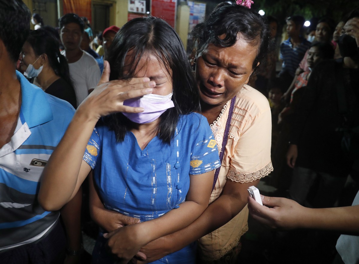 epa09530198 A released woman (L) reacts as she meets with her mother outside the Insein prison in Yangon, Myanmar, 18 October 2021. Myanmar's junta chief Min Aung Haling announced the released of ...
