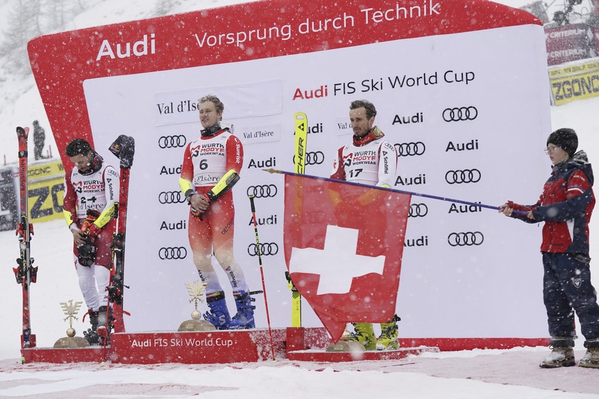 Switzerland&#039;s Marco Odermatt, center, winner of an alpine ski, men&#039;s World Cup giant slalom, poses on podium with second placed Austria&#039;s Patrick Feurstein, left, and third placed Austr ...