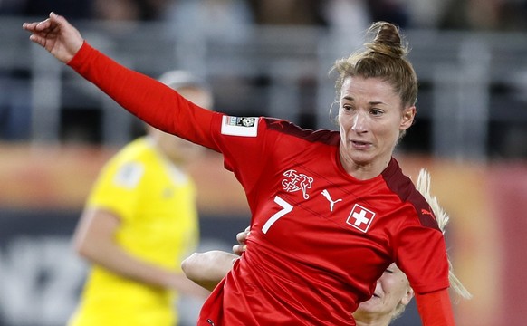 epa09878859 Sandy Maendly (front) of Switzerland in action against Ioana Andrada Bortan (back) of Romania during the FIFA Women's World Cup qualifying soccer match between Romania and Switzerland ...