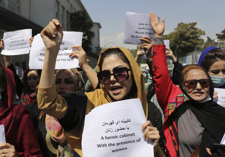 Women gather to demand their rights under the Taliban rule during a protest in Kabul, Afghanistan, Friday, Sept. 3, 2021. As the world watches intently for clues on how the Taliban will govern, their  ...