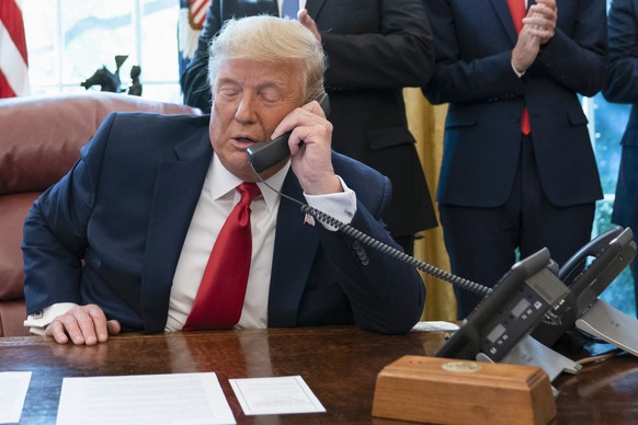 FILE - In this Oct. 23, 2020, photo, President Donald Trump talks on a phone during a call with the leaders of Sudan and Israel in the Oval Office of the White House, in Washington. White House call l ...