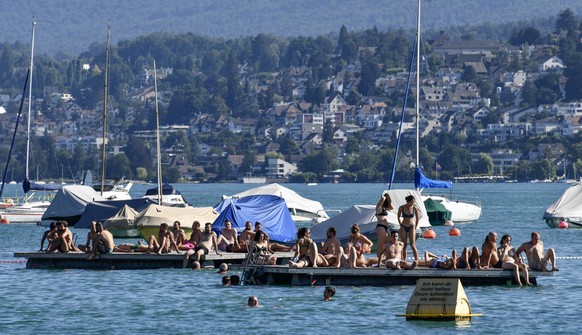 People cool down during temperatures over 30 degrees Celsius (89 F) on Lake Zurich in Zurich, Switzerland, Monday, July 18, 2022 during a heat wave across Europe. (AP Photo/Martin Meissner)