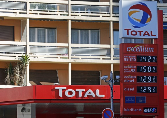 A logo is seen over prices at French oil and gas company Total gas station in Marseille, February 11, 2015. The French oil and gas company Total SA will present its 2014 annual results on Thursday. RE ...