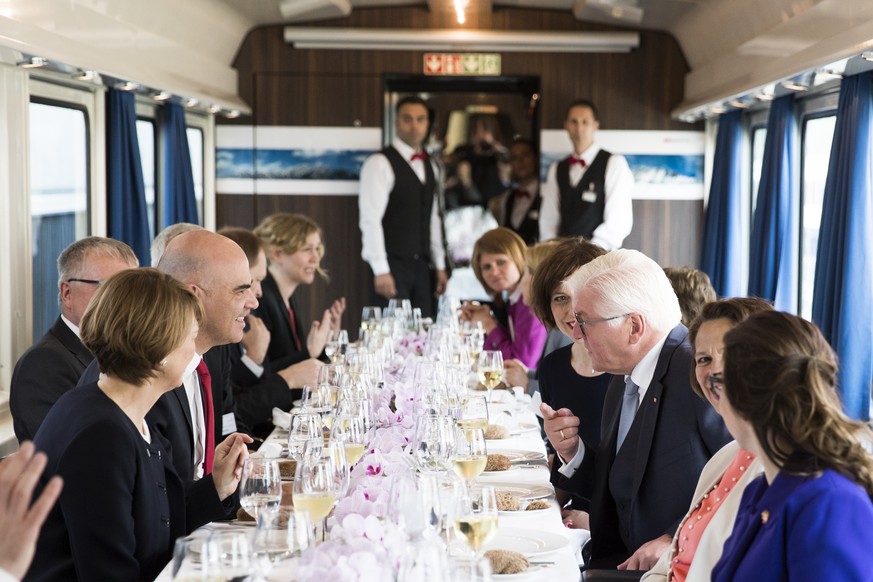 Swiss Federal President Alain Berset, center left, talks to German President Frank-Walter Steinmeier, center right, during a train ride to Bern, during Steinmeier&#039;s two days state visit to Switze ...