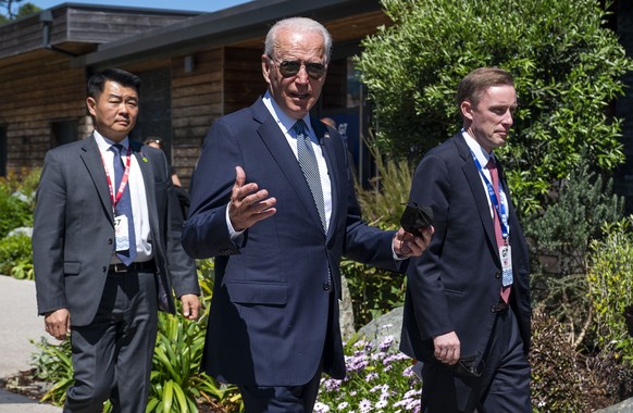 President Joe Biden walks with national security adviser Jake Sullivan, right, and members of the Secret Service as he arrives for the final session of the G-7 summit in Carbis Bay, England, Sunday, J ...