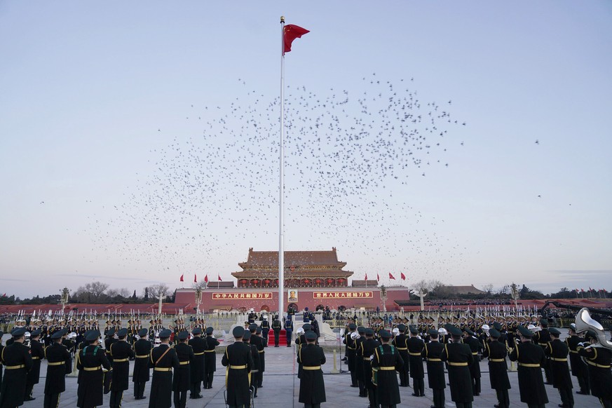 In this photo provided by Xinhua News Agency, the Guard of Honor of the Chinese People&#039;s Liberation Army (PLA) perform the national flag-raising duty on Tian&#039;anmen Square in Beijing, China,  ...