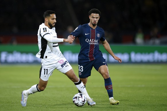 epa12575623 Warren Zaire-Emery (R) of PSG and Mousa Al-Tamari (L) of Rennes in action during the French Ligue 1 soccer match between Paris Saint Germain and Stade Rennais FC in Paris, France, 06 Decem ...