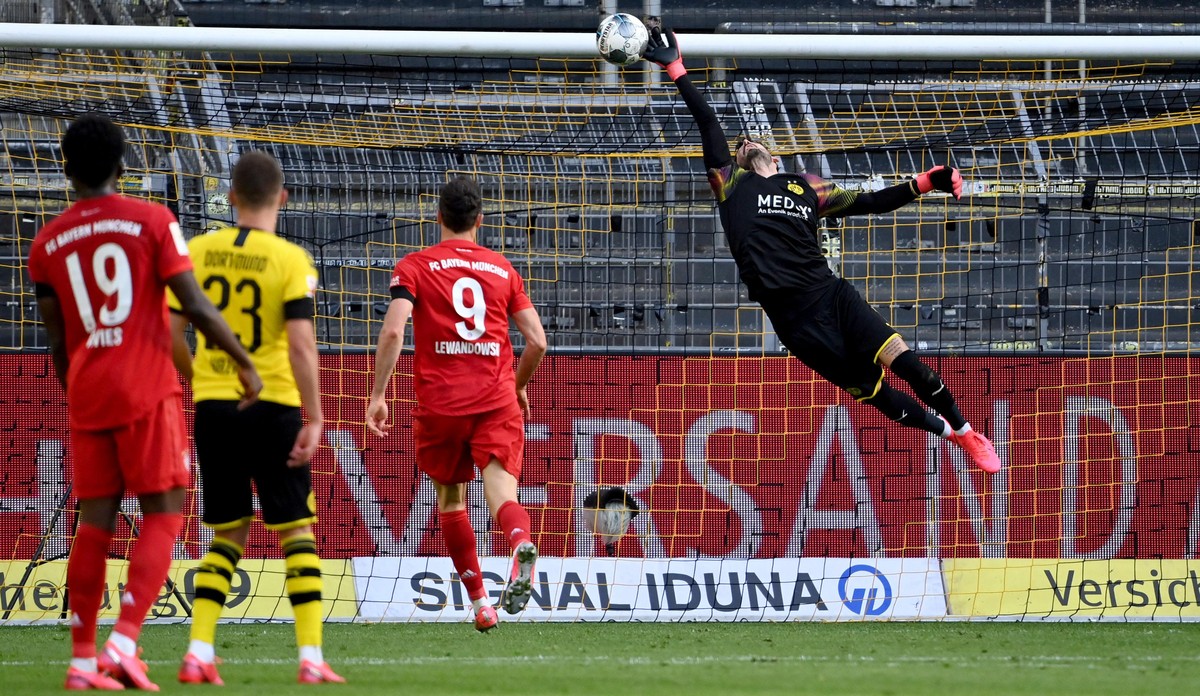 epa08445438 Dortmund's goalkeeper Roman Buerki (R) concedes the 0-1 goal scored by Bayern Munich's Joshua Kimmich (not pictured) during the German Bundesliga soccer match between Borussia Do ...