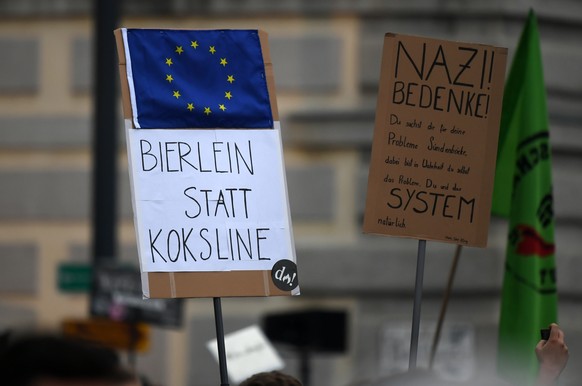 epa07613324 A placard reading a play of words &#039;Bierlein instead of coke line&#039; is held as Dutch pop group &#039;Vengaboys&#039; perform their song &#039;We’re Going To Ibiza!&#039; at the &#0 ...