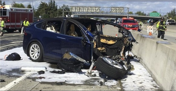 In this Friday March 23, 2018 photo provided by KTVU, emergency personnel work a the scene where a Tesla electric SUV crashed into a barrier on U.S. Highway 101 in Mountain View, Calif. The National T ...