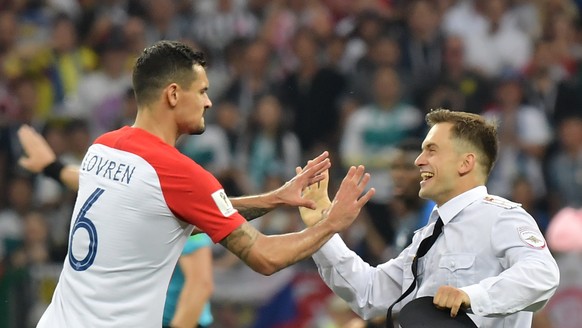 epa06891112 Dejan Lovren of Croatia argues with a pitch invader during the FIFA World Cup 2018 final between France and Croatia in Moscow, Russia, 15 July 2018.

(RESTRICTIONS APPLY: Editorial Use O ...