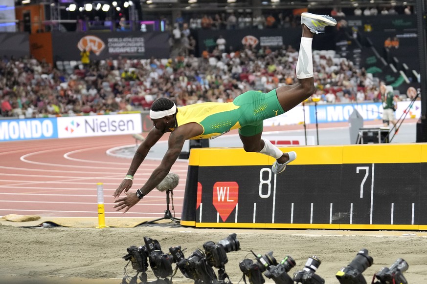 Carey Mcleod, of Jamaica, loses control as he competes in the men&#039;s long jump final during the World Athletics Championships in Budapest, Hungary, Thursday, Aug. 24, 2023. (AP Photo/Ashley Landis ...